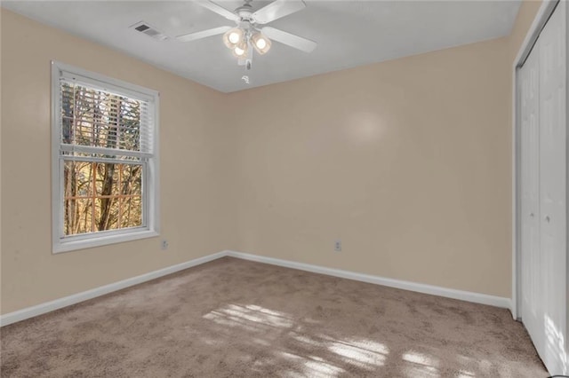 unfurnished bedroom featuring a closet, visible vents, carpet, and baseboards