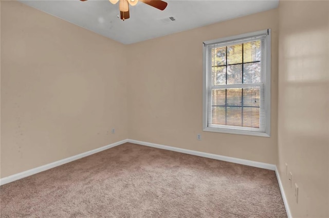 empty room with a ceiling fan, baseboards, visible vents, and carpet floors