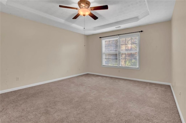 unfurnished room with a ceiling fan, baseboards, visible vents, a raised ceiling, and carpet flooring