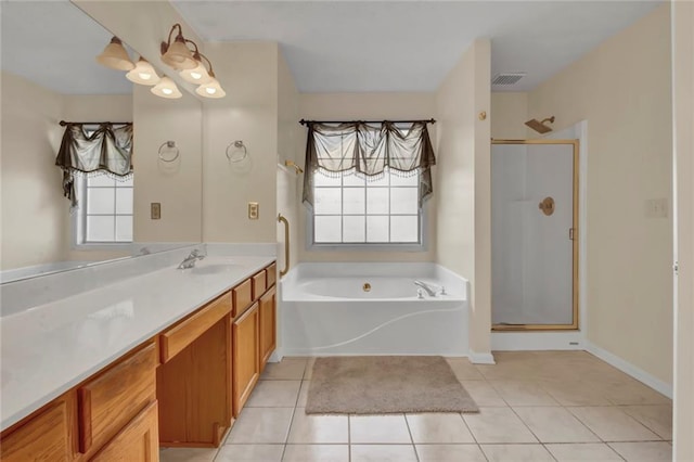 full bath featuring tile patterned floors, plenty of natural light, a stall shower, and vanity