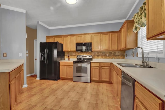 kitchen featuring decorative backsplash, black appliances, light countertops, and a sink