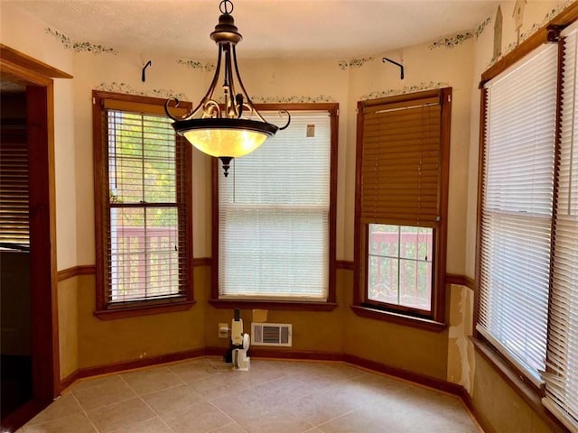 unfurnished dining area featuring light tile patterned floors