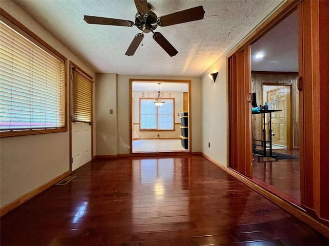 spare room with wood-type flooring, a textured ceiling, and ceiling fan