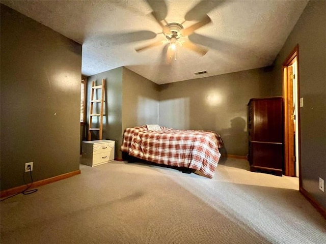 unfurnished bedroom with carpet, a textured ceiling, and ceiling fan