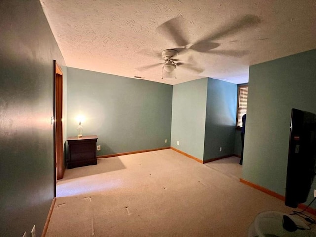 interior space with a textured ceiling and ceiling fan