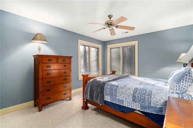 bedroom with light carpet, baseboards, visible vents, and a ceiling fan