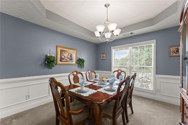 27 Kendall Creek Dr, Jefferson, GA 30549 - dining area with a wainscoted wall, light carpet, a chandelier, and a raised ceiling