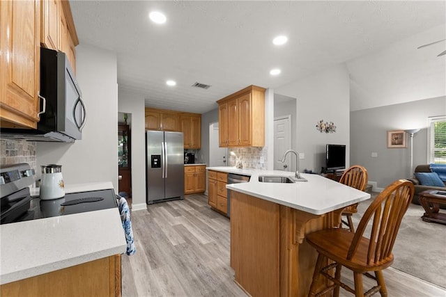 27 Kendall Creek Dr, Jefferson, GA 30549 - kitchen featuring stainless steel appliances, a peninsula, open floor plan, a kitchen breakfast bar, and recessed lighting