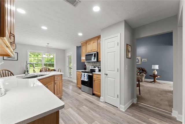 27 Kendall Creek Dr, Jefferson, GA 30549 - kitchen featuring appliances with stainless steel finishes, light countertops, light wood-style flooring, recessed lighting, and decorative backsplash