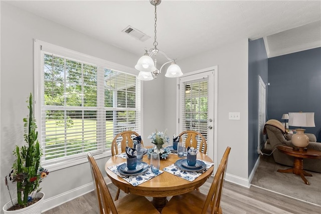 27 Kendall Creek Dr, Jefferson, GA 30549 - dining space with a chandelier, wood finished floors, and plenty of natural light
