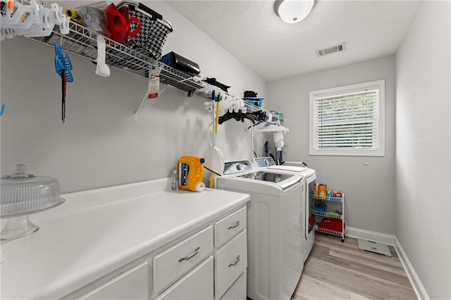 27 Kendall Creek Dr, Jefferson, GA 30549 - laundry room featuring washing machine and clothes dryer, light wood-style flooring, and cabinet space