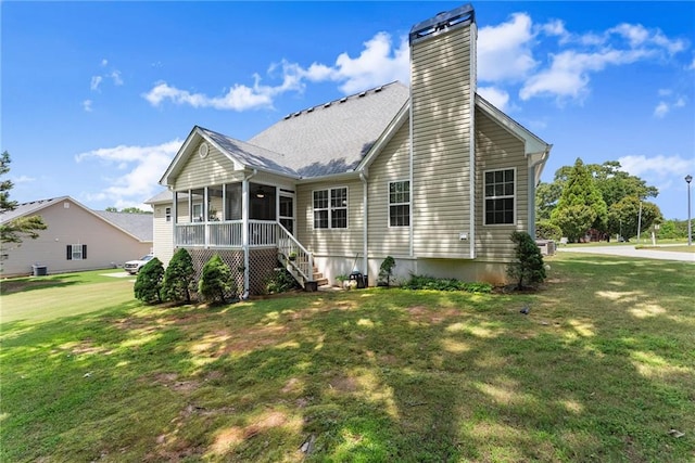 27 Kendall Creek Dr, Jefferson, GA 30549 - back of property with a sunroom, a chimney, and a yard