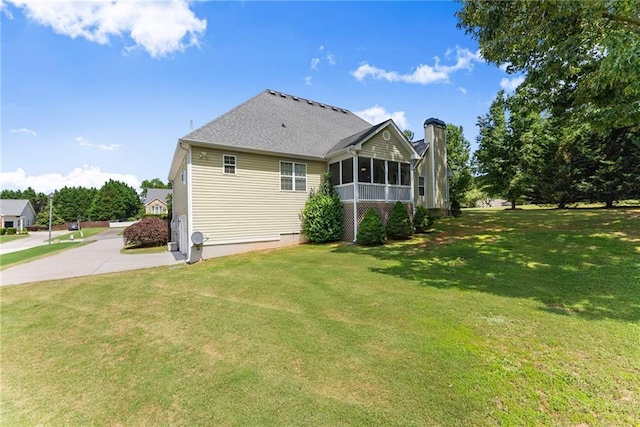 27 Kendall Creek Dr, Jefferson, GA 30549 - back of property with a sunroom, a yard, a chimney, and concrete driveway