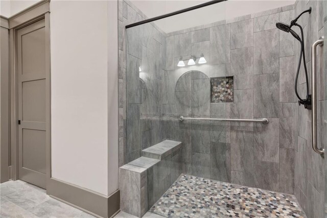 bathroom featuring a shower with shower door