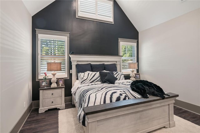 bedroom featuring lofted ceiling and dark hardwood / wood-style flooring