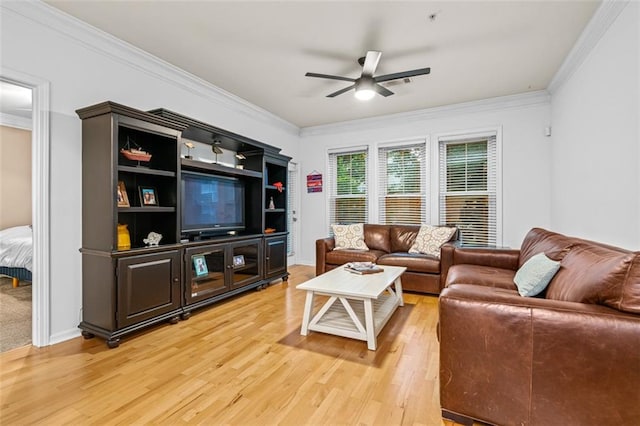 living room with ornamental molding, wood finished floors, a ceiling fan, and baseboards