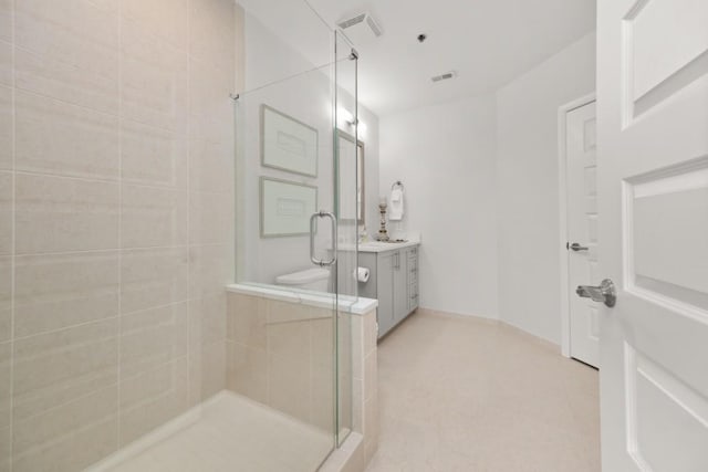 full bathroom with tile patterned floors, visible vents, a stall shower, and vanity