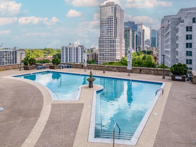 pool with a city view and a patio