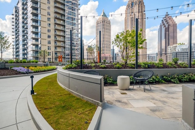 view of home's community featuring a view of city and a patio area