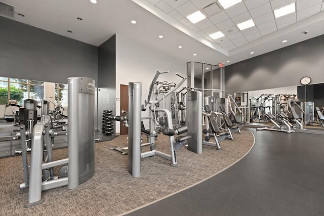 gym with visible vents, recessed lighting, a high ceiling, and a drop ceiling