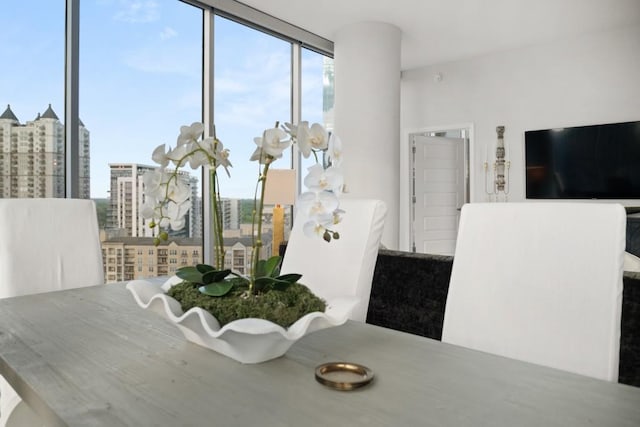 dining area featuring a view of city and floor to ceiling windows