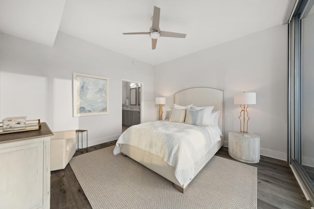 bedroom with dark wood finished floors, a ceiling fan, baseboards, and ensuite bathroom