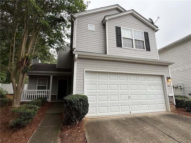 traditional-style house with an attached garage, covered porch, and driveway