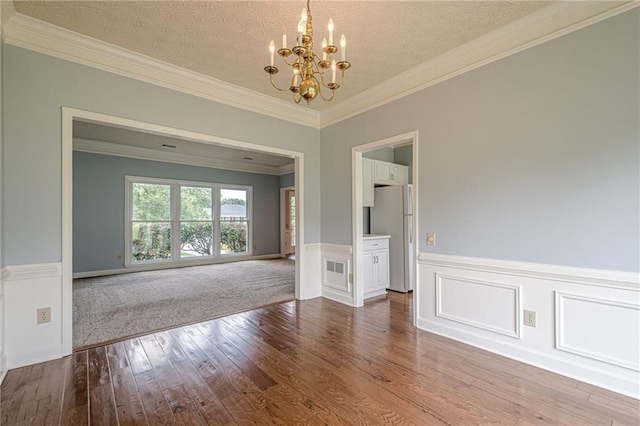 2794 Craig Ct, Marietta, GA 30062 - empty room featuring a chandelier, hardwood / wood-style flooring, a wainscoted wall, and crown molding