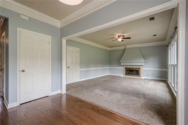 2794 Craig Ct, Marietta, GA 30062 - unfurnished living room with a textured ceiling, ceiling fan, dark wood-style flooring, a large fireplace, and ornamental molding