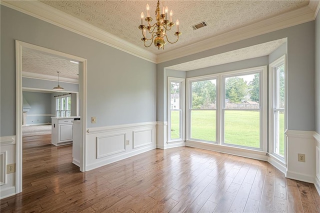 2794 Craig Ct, Marietta, GA 30062 - spare room featuring a chandelier, a wainscoted wall, wood finished floors, and ornamental molding