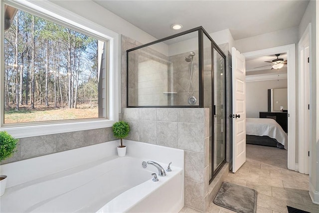 2320 Ridge View Dr, Loganville, GA 30052 - bathroom featuring a garden tub, a shower stall, ensuite bathroom, and ceiling fan
