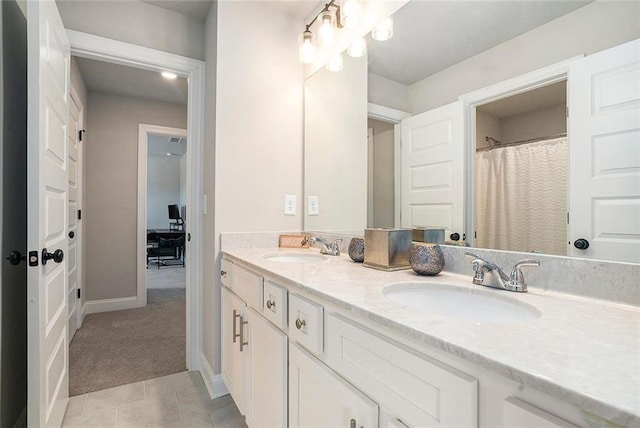 2320 Ridge View Dr, Loganville, GA 30052 - bathroom with double vanity, baseboards, and tile patterned flooring