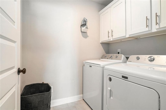 2320 Ridge View Dr, Loganville, GA 30052 - laundry room featuring washer and clothes dryer, cabinet space, baseboards, and light tile patterned flooring