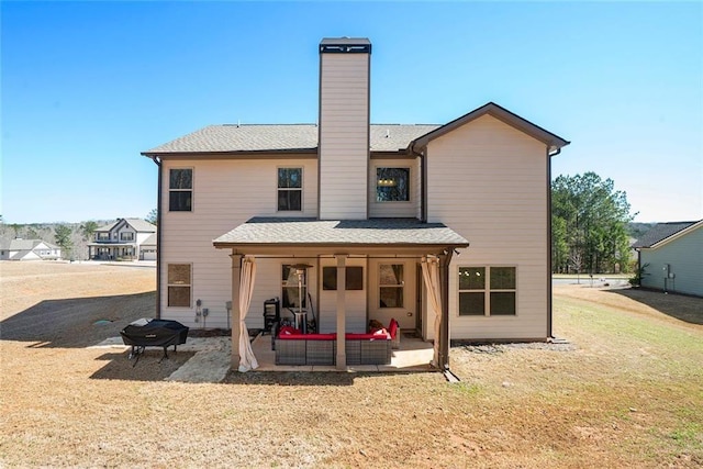 2320 Ridge View Dr, Loganville, GA 30052 - back of property featuring a patio area, a chimney, a fire pit, and a yard