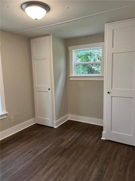 spare room with dark hardwood / wood-style flooring