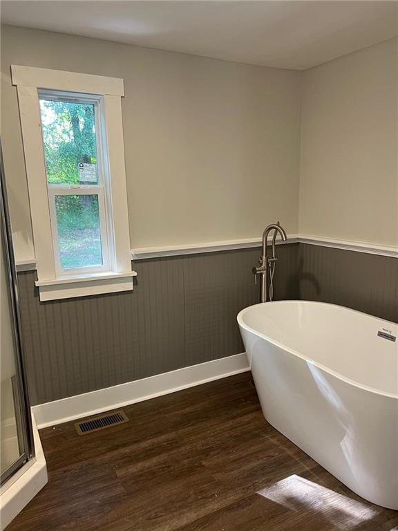 bathroom featuring hardwood / wood-style flooring and separate shower and tub