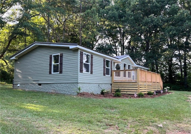 view of home's exterior with a lawn and a wooden deck