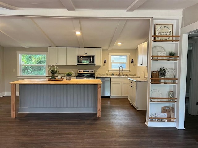 kitchen featuring white cabinetry, butcher block counters, dark hardwood / wood-style flooring, a kitchen island, and appliances with stainless steel finishes