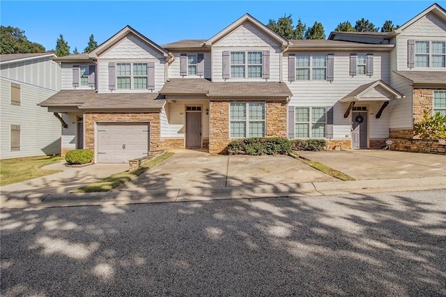 multi unit property with stone siding and concrete driveway