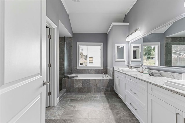 full bath featuring a garden tub, crown molding, double vanity, a tile shower, and a sink