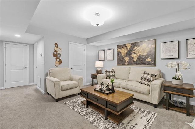 carpeted living area featuring baseboards and recessed lighting