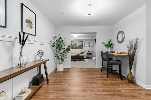 interior space with wood finished floors and baseboards