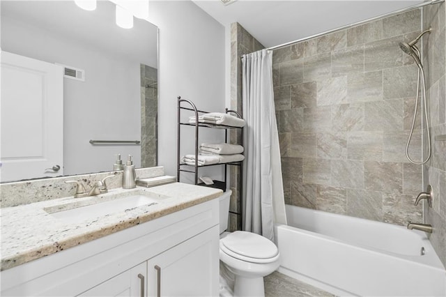 bathroom featuring visible vents, vanity, toilet, and shower / bath combo with shower curtain