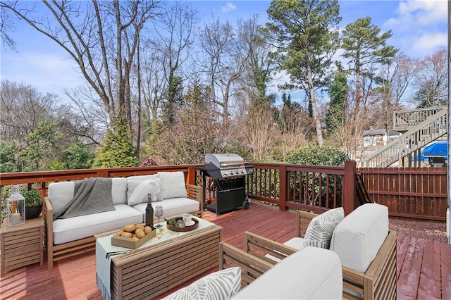 wooden terrace with a grill and an outdoor hangout area