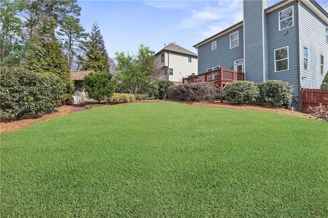 view of yard with a deck and fence