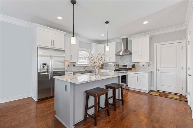 kitchen featuring a kitchen island, white cabinets, appliances with stainless steel finishes, dark wood-style floors, and wall chimney exhaust hood