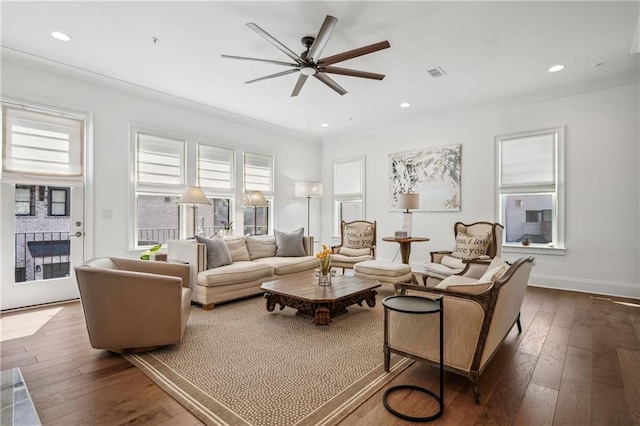 living room featuring visible vents, recessed lighting, crown molding, and dark wood-type flooring