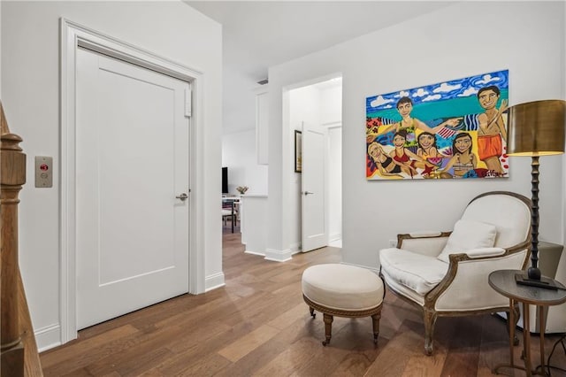 sitting room with wood finished floors and baseboards