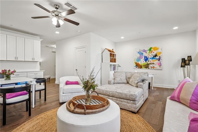 living area featuring recessed lighting, wood finished floors, visible vents, and baseboards