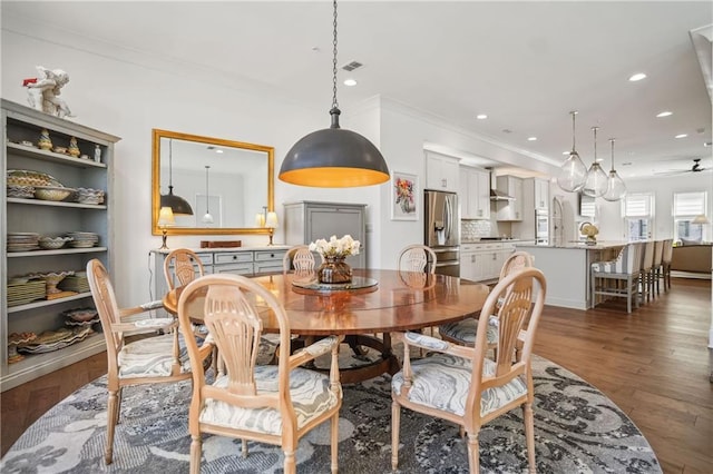 dining space with recessed lighting, visible vents, ornamental molding, and wood finished floors